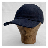 inspired by vintage US Navy ship caps, 1970s “trucker” hats, baseball caps, and other classic promotional headwear.